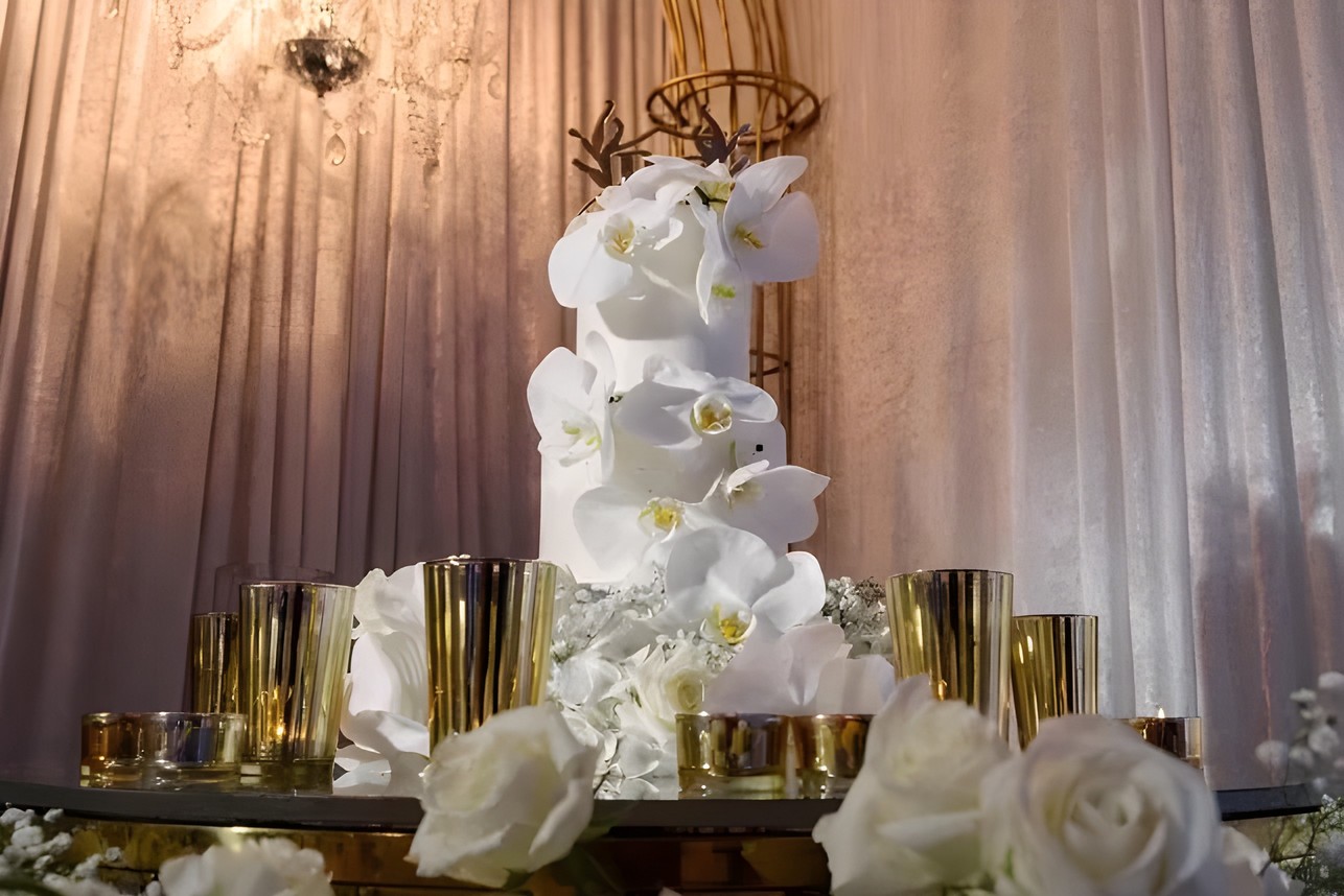 White orchid wedding cake with gold accents by Sharp Designs