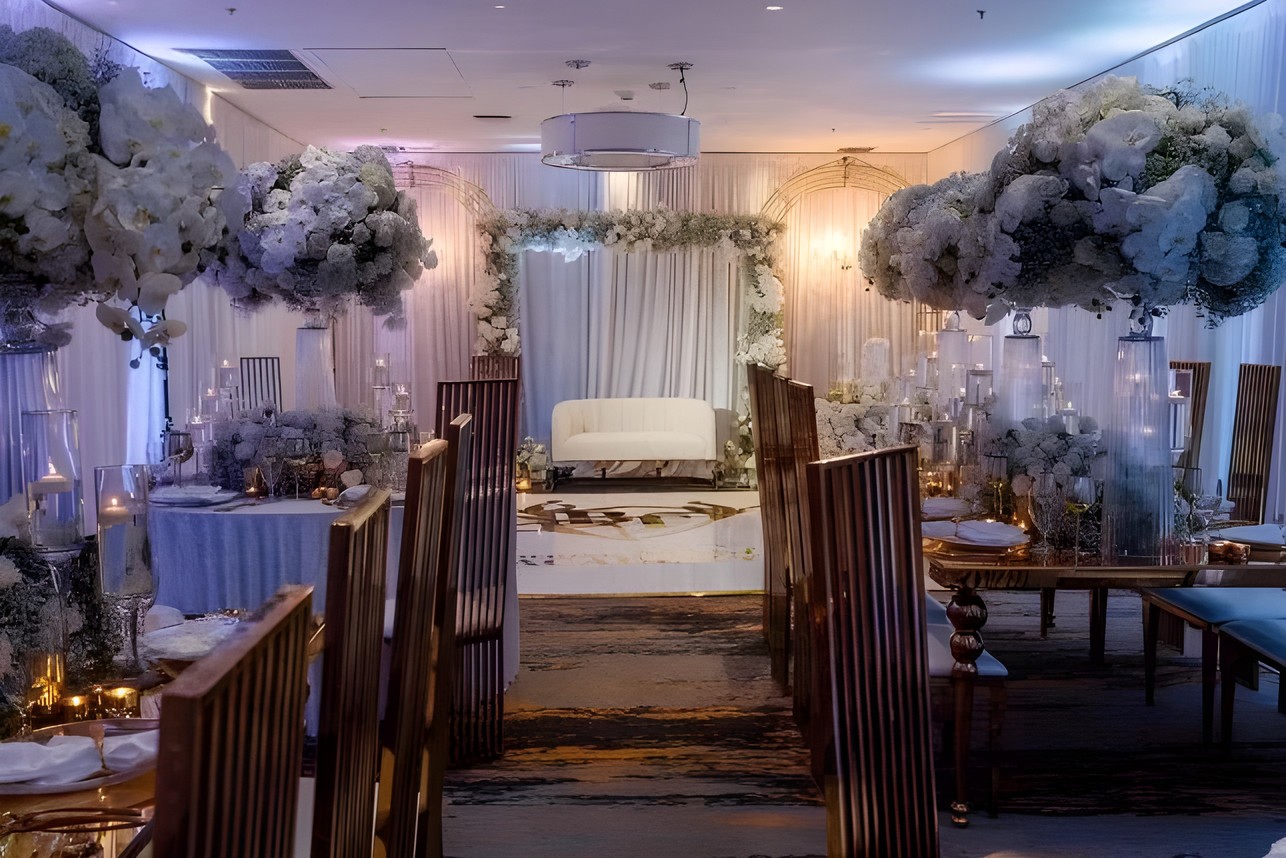 Wedding reception aisle with white florals and gold chairs by Sharp Designs