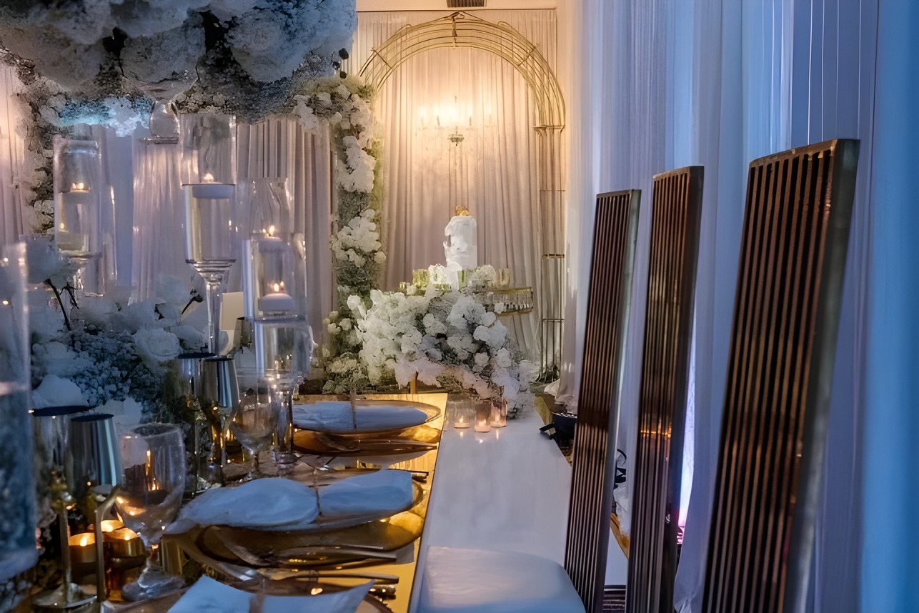 Wedding tablescape with tall floral arrangements and candlelight by Sharp Designs