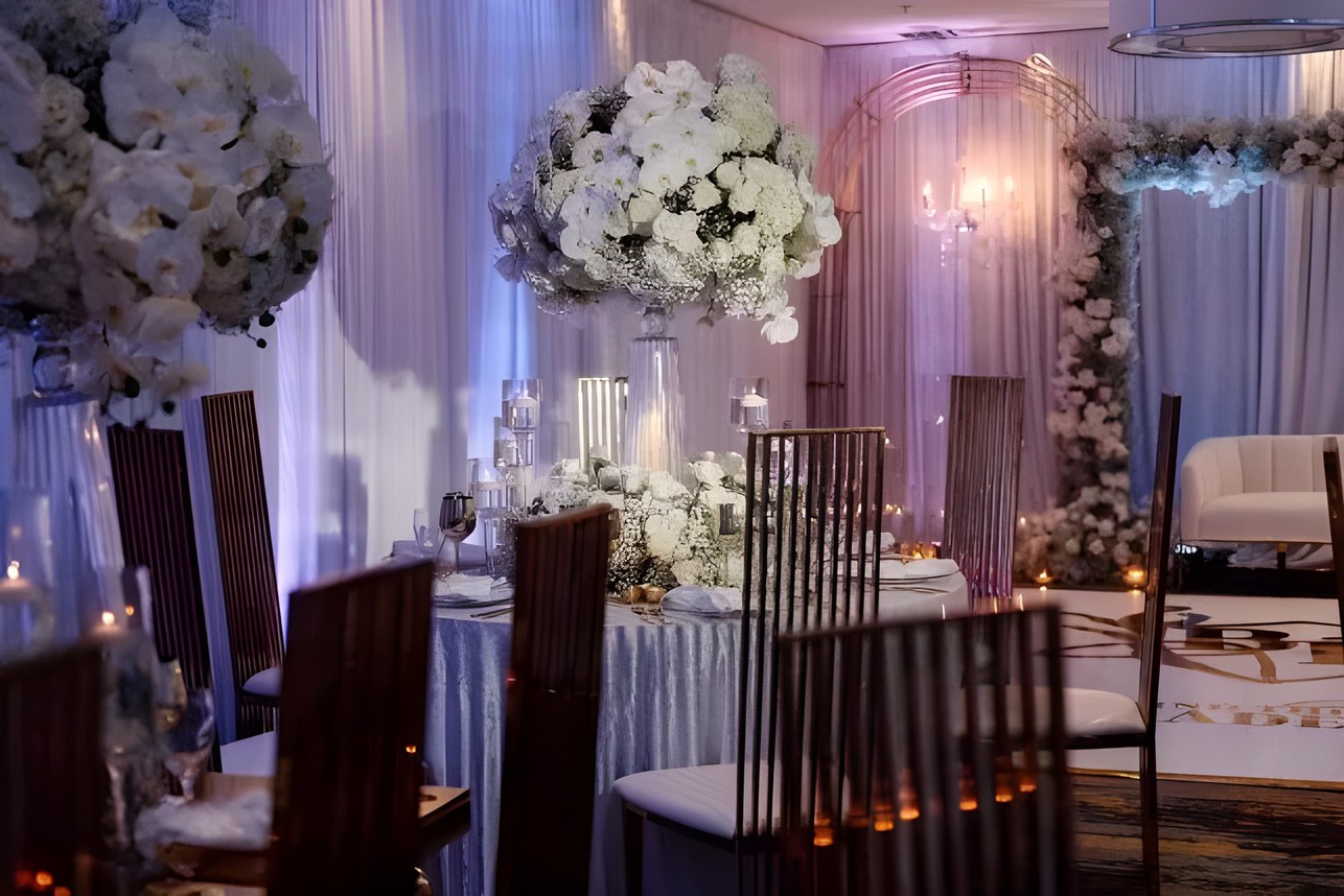 Wedding ballroom styling with uplighting and white florals by Sharp Designs
