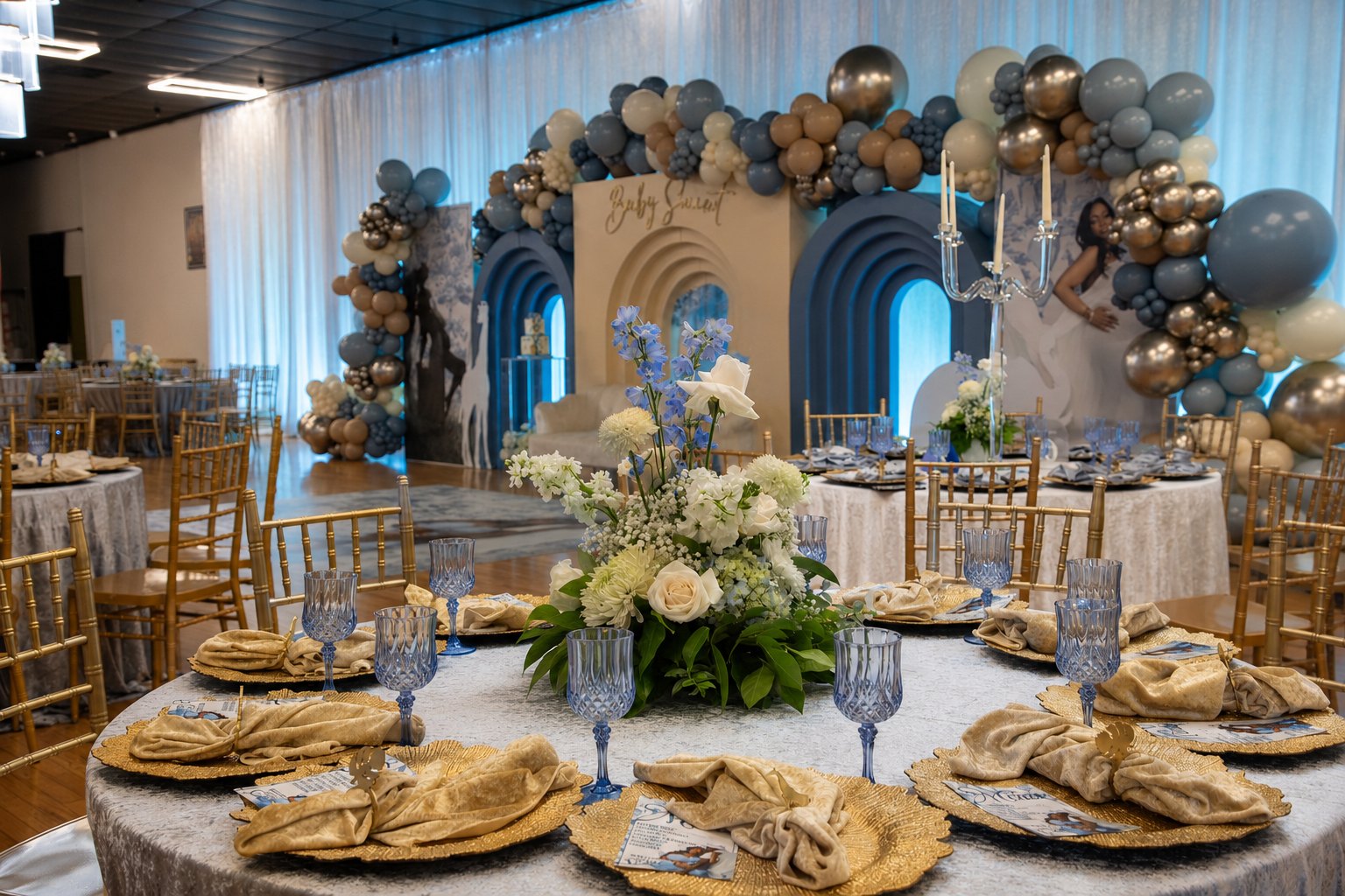Blue and gold ballroom transformation with arched backdrops, gold chiavari chairs and floral centrepieces by Sharp Designs